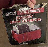 Photo of the original box showing the Chicago Electric Power Tools rotary rock tumbler in red with 3 lb. capacity.