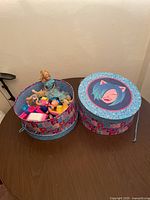 Two large Rocket Cat hat boxes, one with lid on and one with lid off, showing toys inside