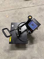 Top-down view of digital heat press showing control panel, swing-away arm, handle and lower platen