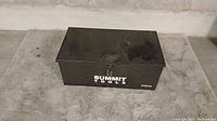 Closed black metal toolbox with Summit Tools branding on the front, placed on concrete surface.