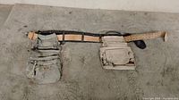 Full view of the tool belt laid flat showing both the left and right pouch sections and the belt with buckle