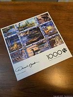 Box front showing Darrell Bush signature, puzzle title 'North Country', piece count 1000, and nature-themed collage artwork on the cover.