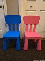 Front view of the two children's chairs, one blue and one pink, showing their design, shape, and size.