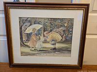 Framed print by Trisha Romance displayed showing full frame and artwork, frame has visible wear marks.