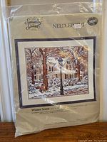 Packaged needlepoint kit showing front design labeled 'Winter Scene' by Something Special with product details and 'NEW' sticker.