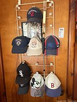 Full rack of nine ball caps with various designs