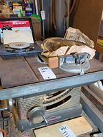 Side view of Craftsman table saw with saw blades and Rockwell dado cutter on top