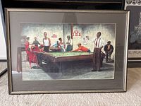 Front view of the framed print showing the entire pool hall scene with nine people around the pool table.
