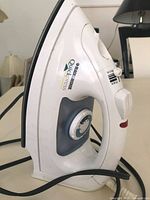 Left profile of Black & Decker Quickpress iron showing overall design and cord