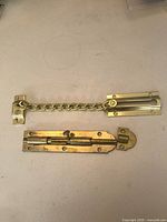 Overview showing both brass door latches: chain guard and barrel bolt