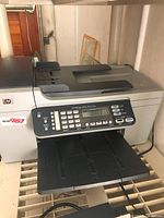 Full view of HP Officejet 5610xi printer on shelf