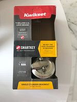 Boxed Kwikset SmartKey single cylinder deadbolt showing product and packaging details