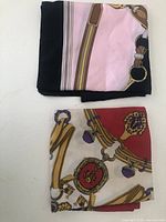 Two folded equestrian print square scarves, different colorways