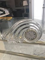 Side view of clear crystal Mikasa desk clock showing wave shape and clock insert