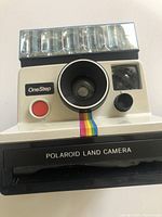 Front view of Polaroid OneStep Land Camera with flash bar attached