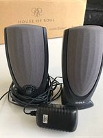 Front view of two Dell speakers with power adapter and cables