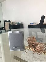 Front view of the RCA speaker with attached copper wire on glass table