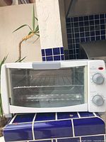 Front view of Rival toaster oven showing glass door and interior rack