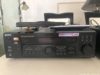 Front view of Sony STR-K740P receiver with remote and RCA cables on top