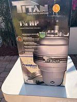 Front of retail box showing Titan branding, 1¼ HP rating and product image