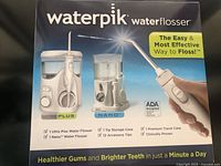 Front of retail box showing both water flossers and included items