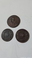 Three vintage Nova Scotia coins including 1823 Half Penny Token and two 1861 One Cent coins shown together on a white background.