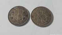 Two British silver Half Crown coins dated 1939 and 1942, showing obverse side with coat of arms and inscriptions.