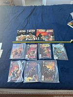 Full set of 12 Star Wars Dark Horse comic books laid out on a blue surface, including 4 issues of the A New Hope series and additional related comics. Some comics are bagged in plastic.