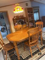 Overall view of rectangular dining table with leaf inserted and six chairs