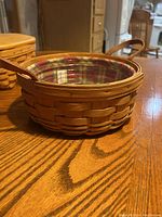Side view of Longaberger basket showing woven wood and handle with fabric liner inside