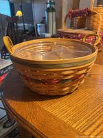 Side view of Longaberger basket showing woven design, wood rim and plastic insert divider