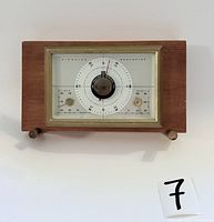 Front view of the Airguide weather station showing the barometer, thermometer, and humidity gauges in wood and brass casing.