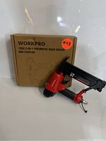 Photo of WORKPRO 18GA 2-in-1 Pneumatic Brad Nailer and Stapler with original box showing product label.