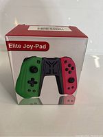 Front view of the Elite Joy-Pad Controller box showing the design and branding with the green and red controller halves.