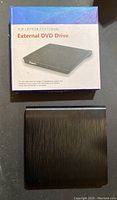 Box for the external DVD drive floating in mid-air, displaying product name and some text.