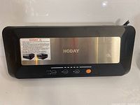 Front view of the Hoday vacuum sealer showing the brand, control buttons, and stainless steel surface.