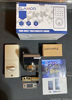 Overview of lot contents with packaging, front and rear lock units, latch bolt, hardware box, and user manual.