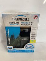 Front view of Thermacell EX90 mosquito repellent packaging showing included 12 repellent mats, rechargeable battery, and 20 ft protection zone.