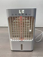 Front view of Bapole CD107 Portable Air Cooler showing power and function buttons with digital display, white plastic body, vertical grille, water tank indicator section.