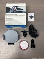 Full lot showing car mount charger, box, manual, mounting parts, and car charger adapter