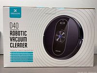 Closed box showing Deenkee D40 Robotic Vacuum Cleaner with product details on the front.