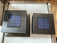 Top view showcasing the solar panels on two different sizes of fence post solar lights.