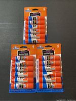 Set of three packs of Elmer's Washable Disappearing Purple School Glue Sticks, each containing 6 sticks, displayed in original packaging.