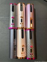 Photo showing all six cordless automatic hair curlers in a variety of colors with visible controls and displays