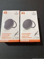 Box packaging of two iQ branded wireless chargers showing front and side, product image and MagSafe compatibility badge