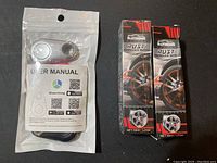 Photo showing packaged user manual with two boxed Rayhong rust remover sprays.