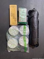 Overview of all items in the bundle including the EMF tester box, sealed mini LED lights, RGB light panels, and umbrella carry bag.