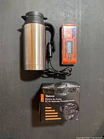 Photo showing the stainless steel car outlet kettle, digital meat thermometer, and AstroAI electric air pump box
