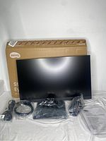BenQ GW2490 monitor with stand, power adapter, cables, and box arranged on white surface.