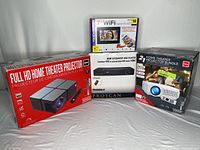Lot contents showing two boxed projectors, one boxed WiFi digital photo frame, and one boxed HDMI DVD player.